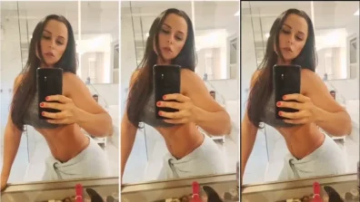 Jessica Minasian in the bathroom showing her belly